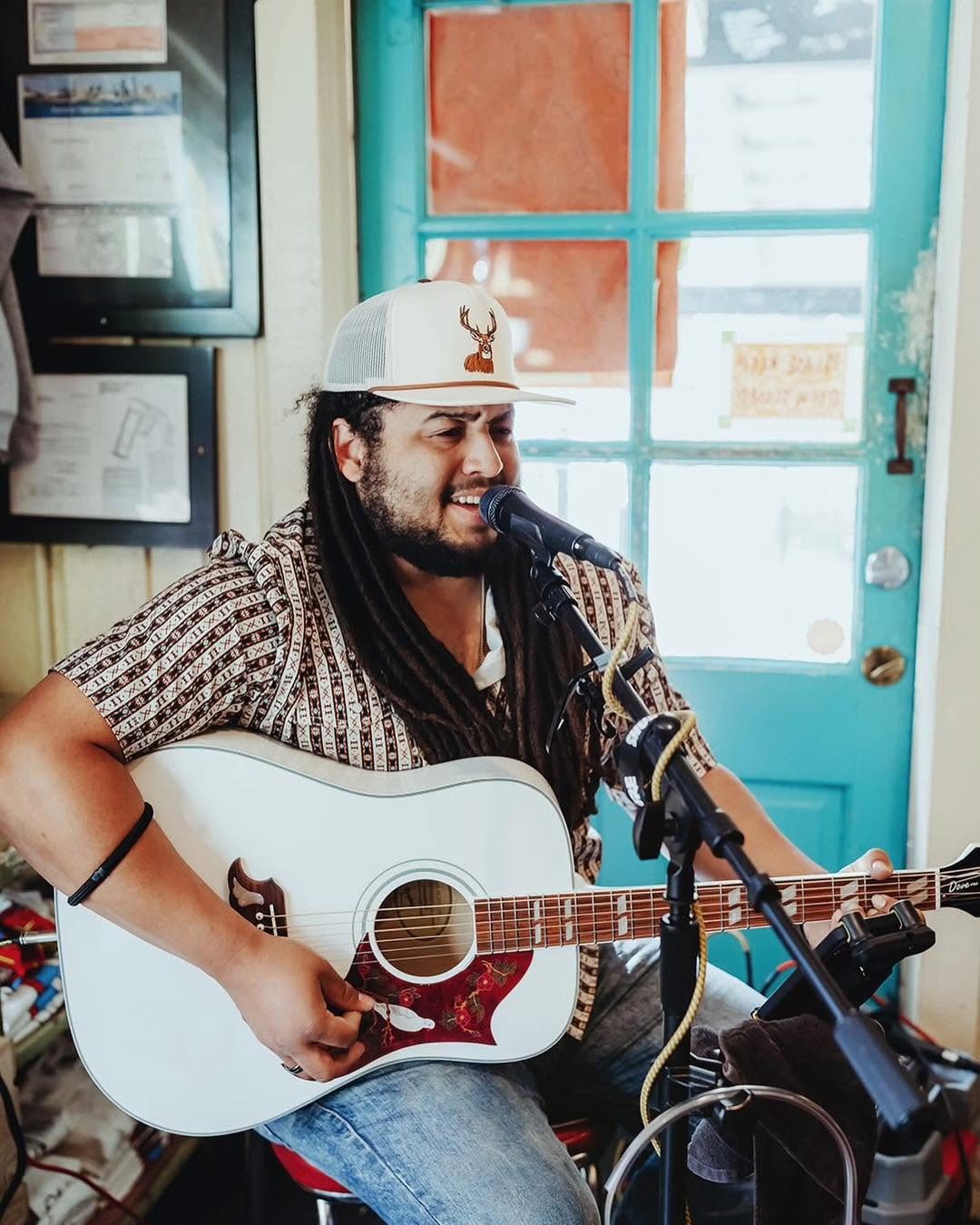 Acoustic musician playing live on a small bar stage